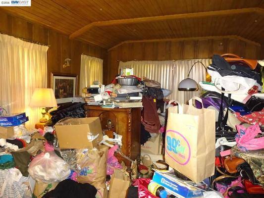 Room cluttered with boxes, bags, and more