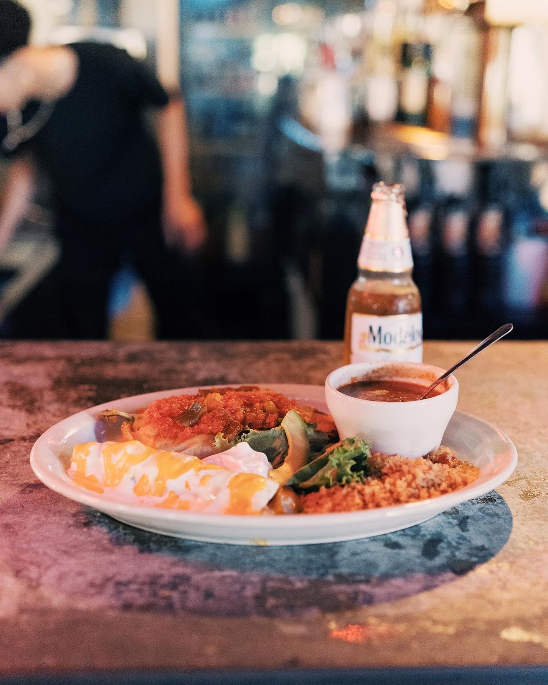 Plate of chile relleno with beer. Photo by Instagram user @losvaquerosstockyards