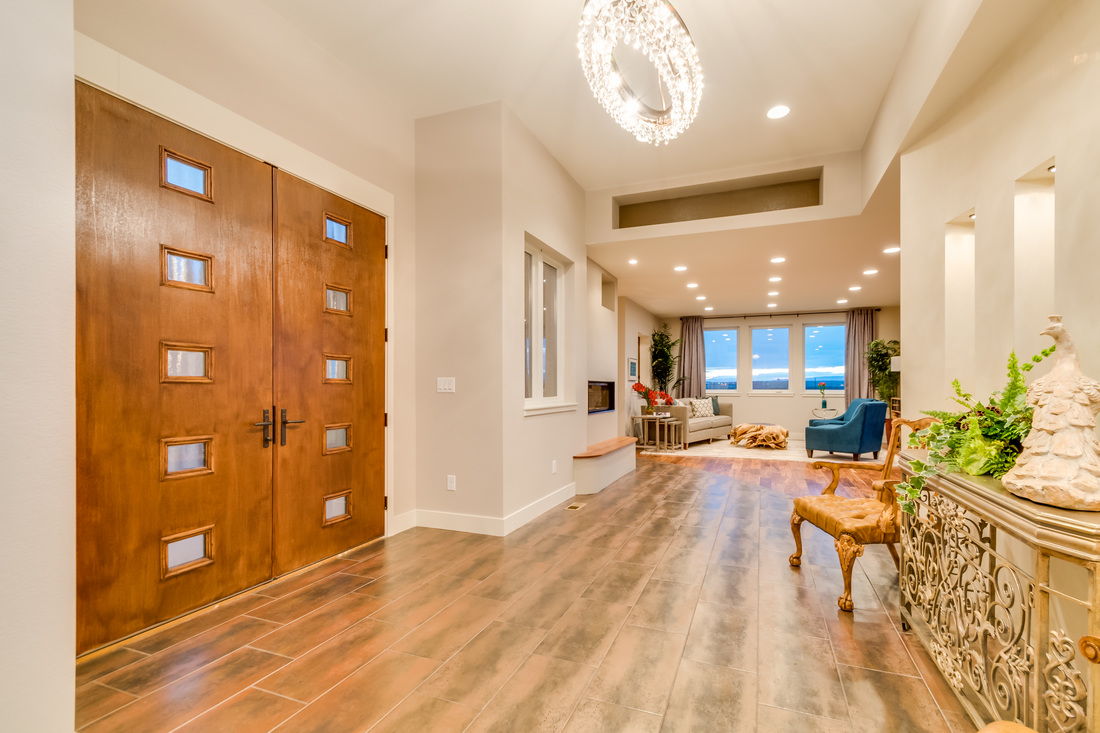 Professional real estate photo of entryway and living room taken by SoCo Home Photography