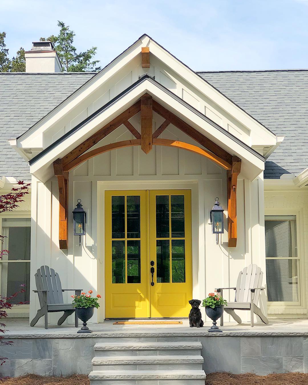 Bright yellow front door on farmhouse. Photo by Instagram user @littleestudio