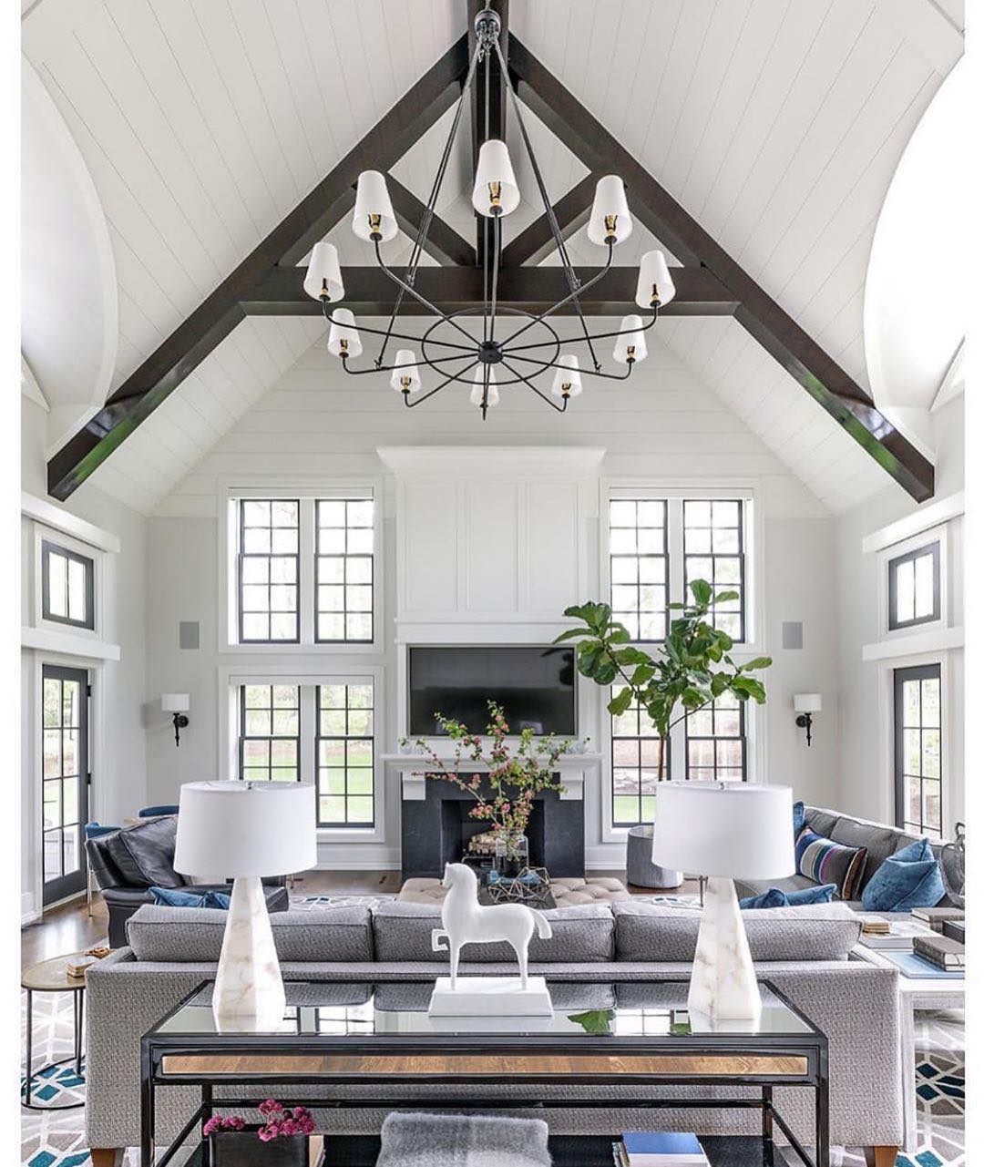 White contemporary living room with high ceilings. Photo by Instagram user @interiordesignbycasswicks