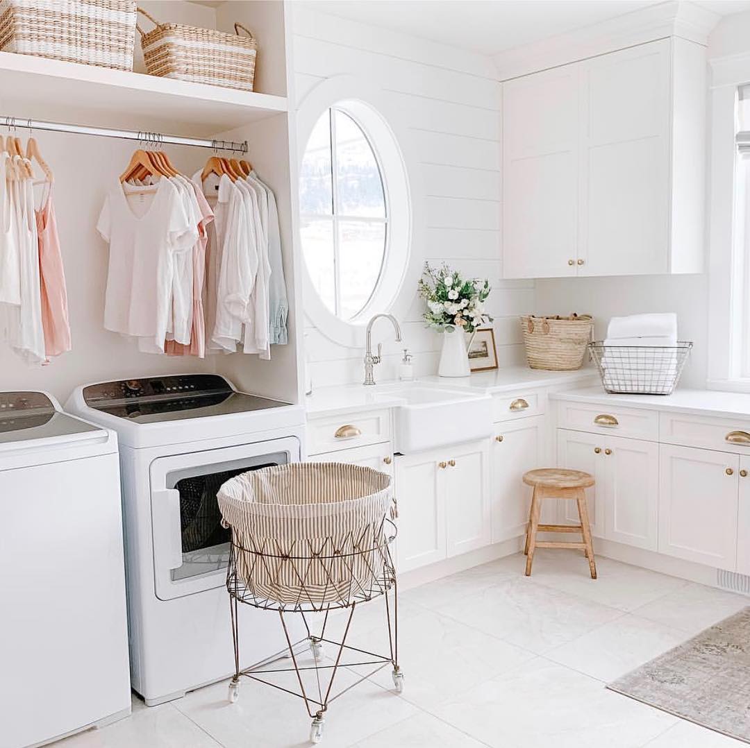 Laundry room with white and pink hues. Photo by Instagram user @thejacobsteam