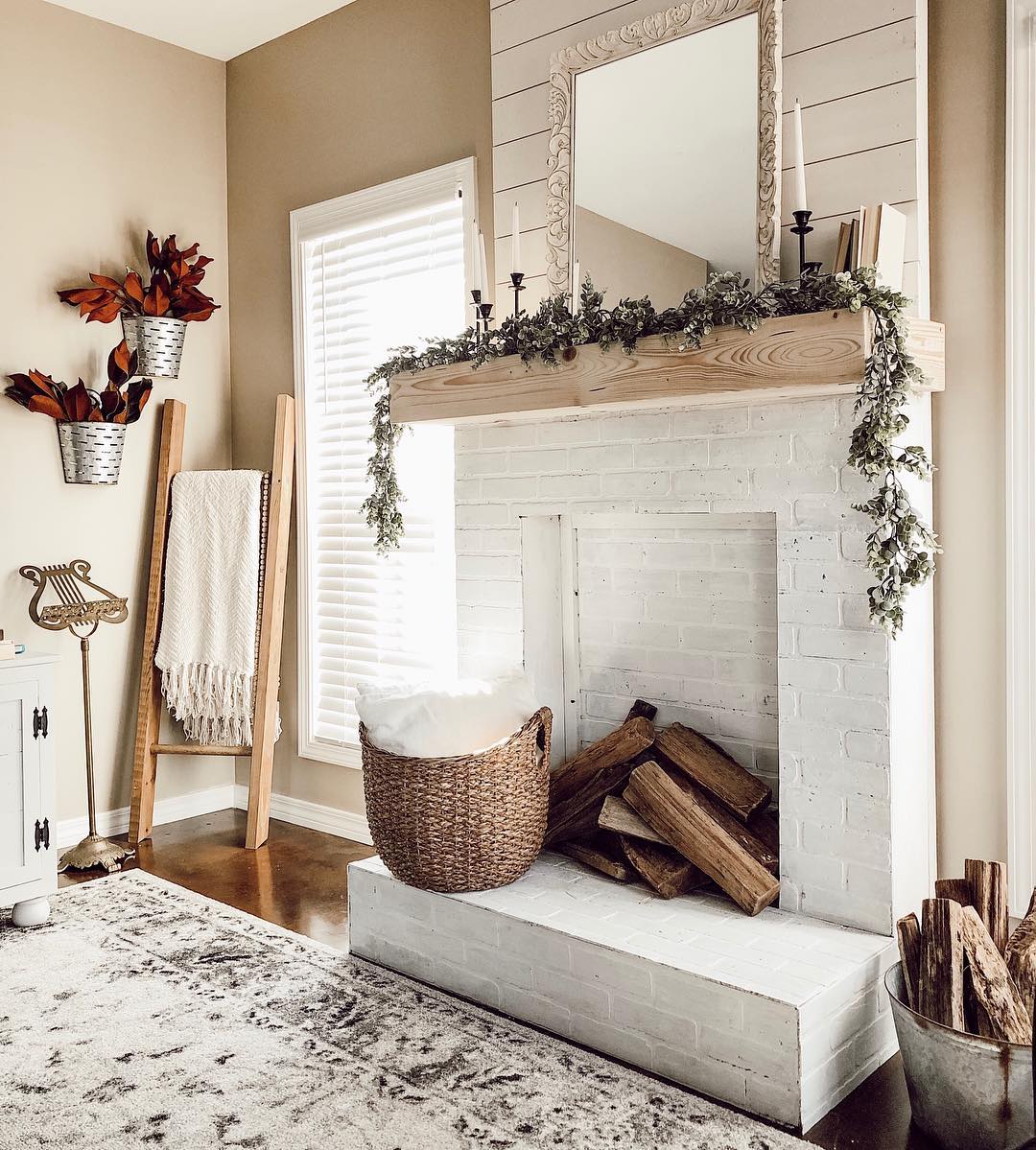 White fireplace and neutral beige walls. Photo by Instagram user @kristenfortier