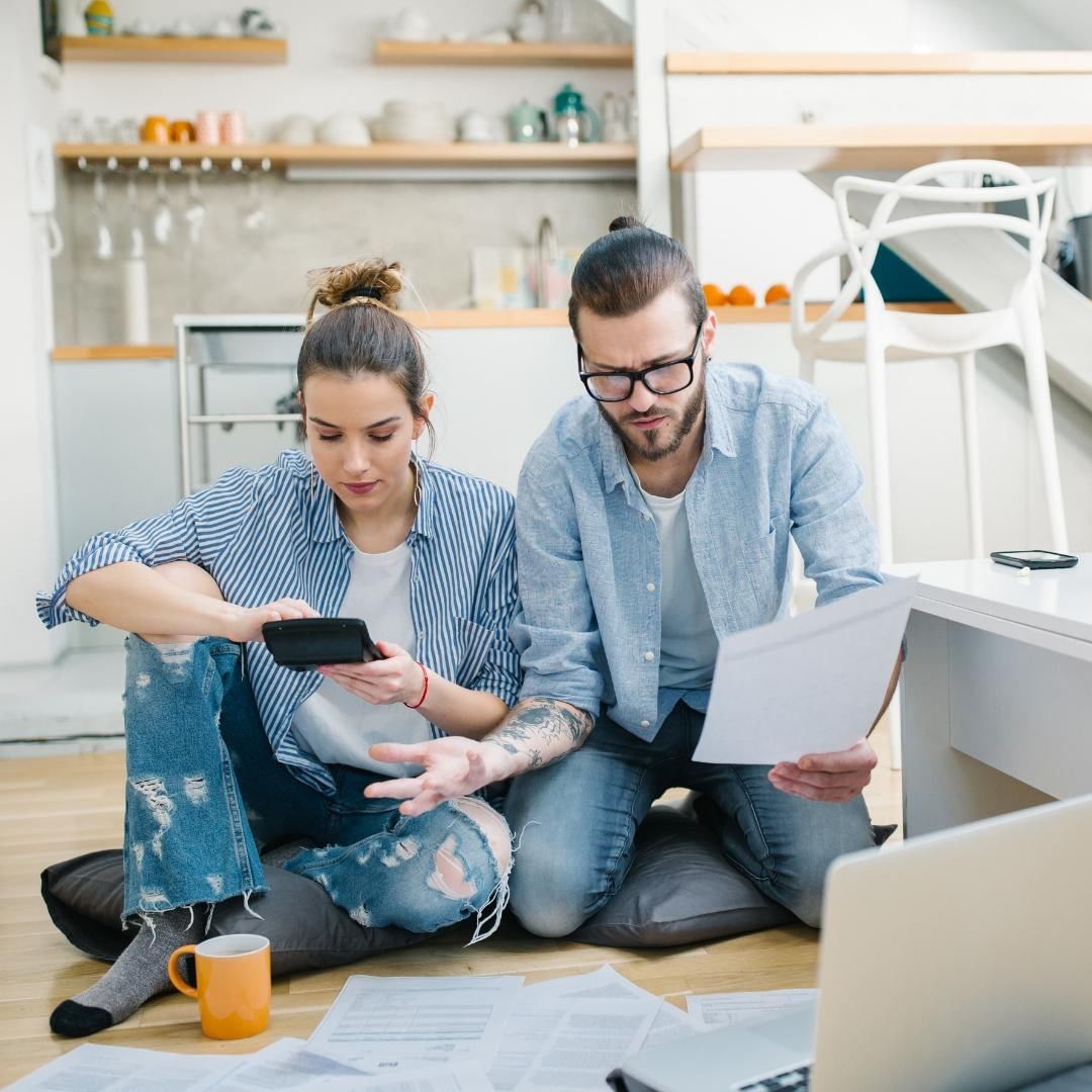 Couple with papers and computer on floor. Photo by Instagram user @miketherealtorrr