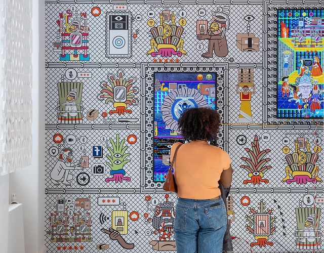 Woman admiring Latinx art pieces. Photo by Instagram user @elmuseo