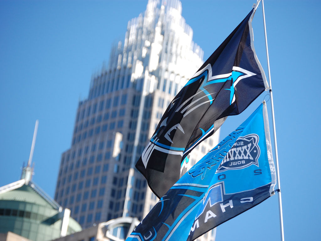 Carolina Panthers flag with Uptown Charlotte skyline in background