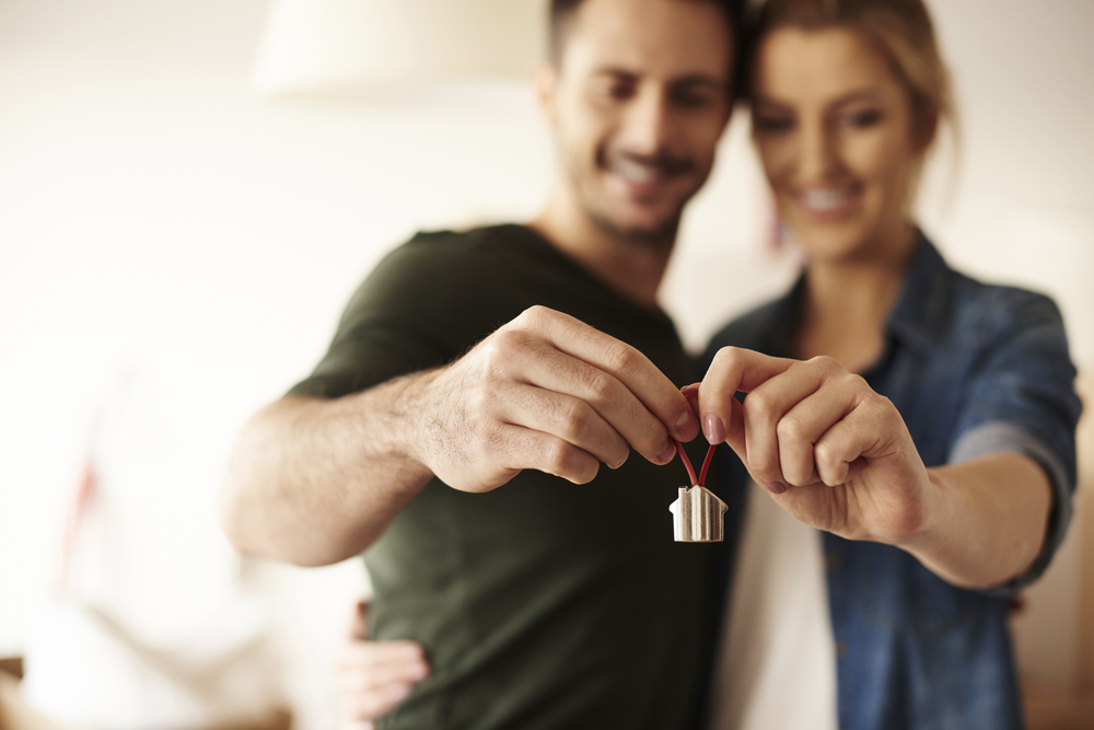 Couple holding house keychain in hands