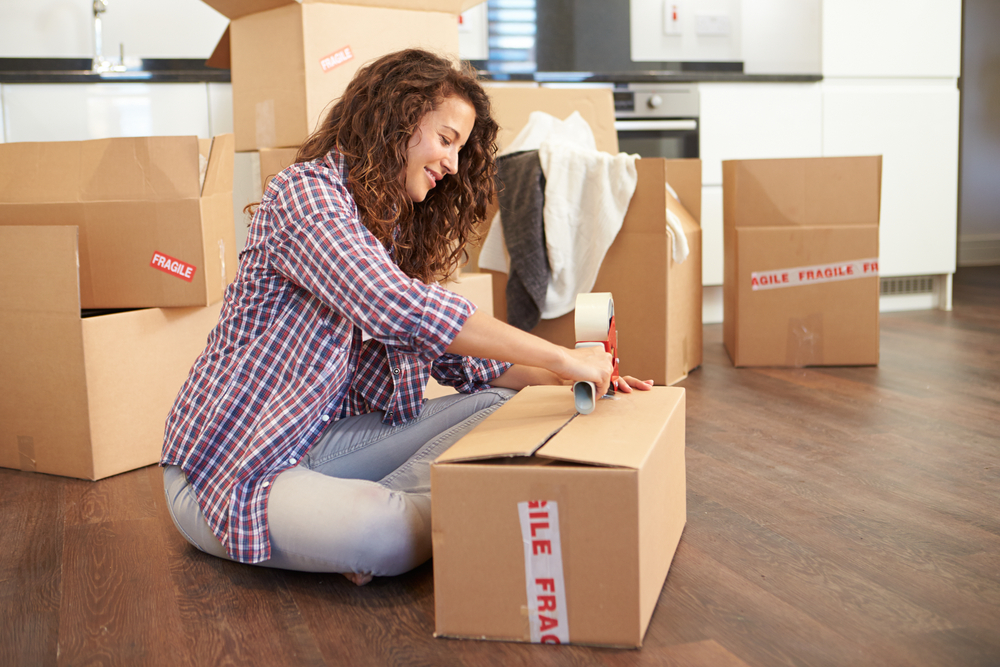 Woman packing moving box