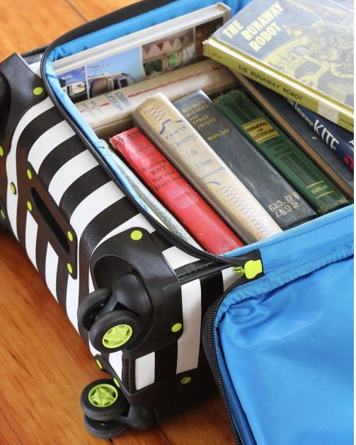 Books in rolling suitcase. Photo by Instagram user @perezbrothersmoving