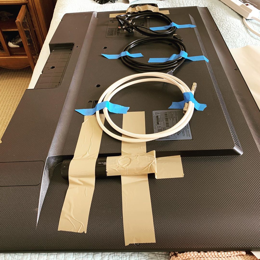 Taped cords to backside of TV. Photo by Instagram user @goldilockssolutions
