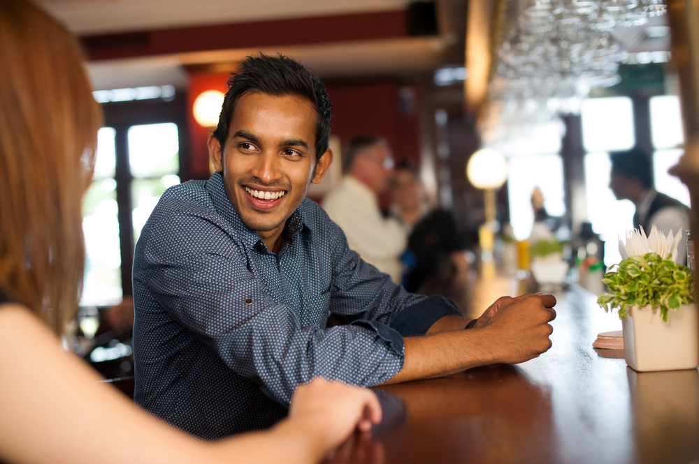 Young man meeting a young woman at a bar