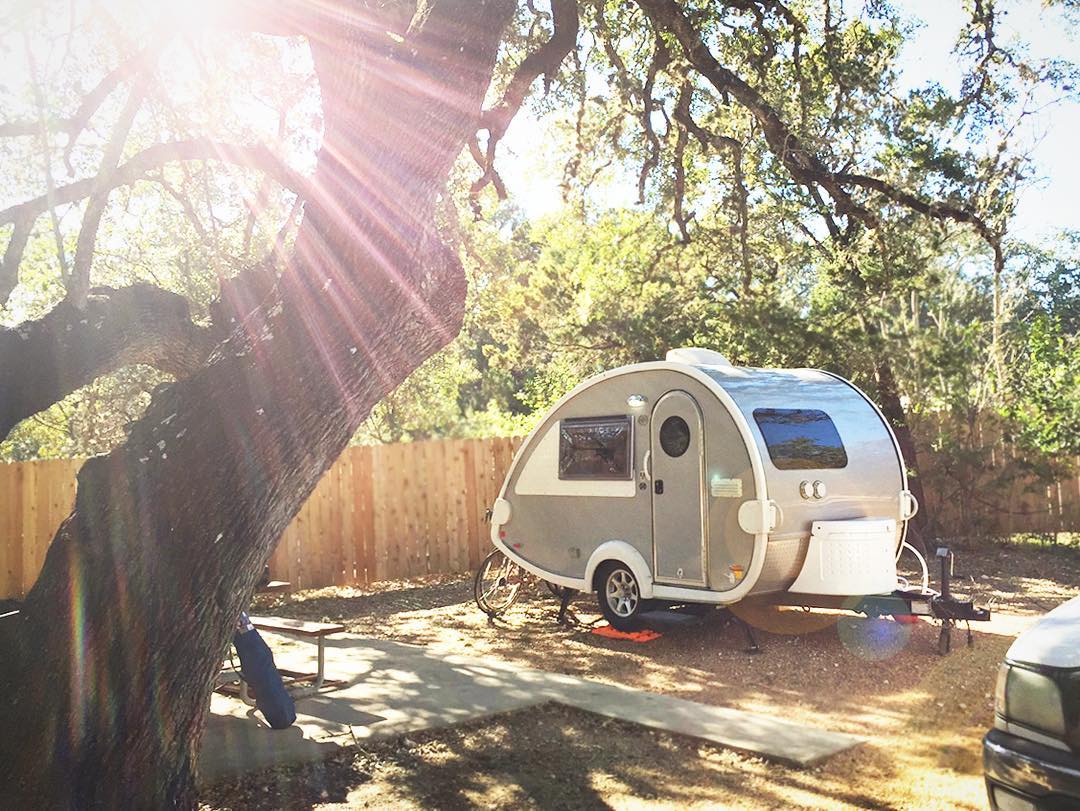Teardrop camper parked at campsite. Photo by Instagram user @happycamperwives