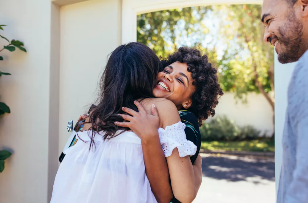 Two women hugging in doorframe