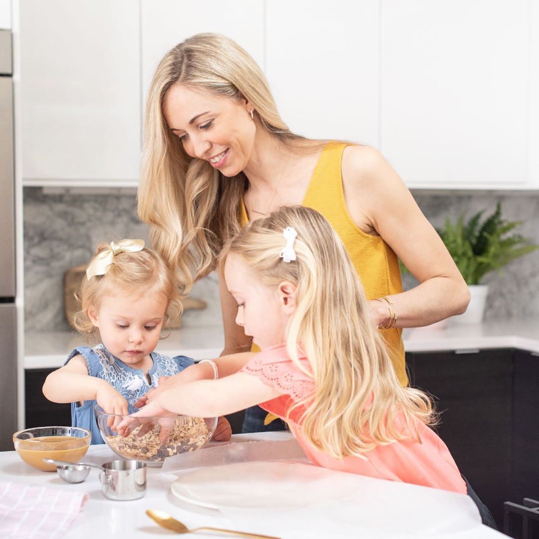 Mother and young daughters making cookies in kitchen. Photo by Instagram user @mytwochickpeas