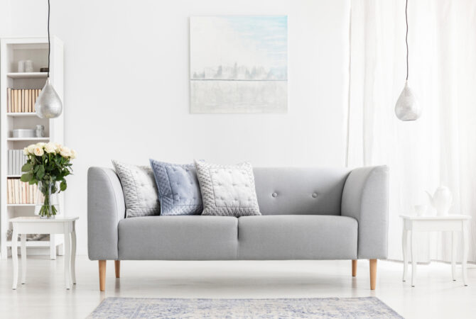 Modern gray couch in minimalist white living room