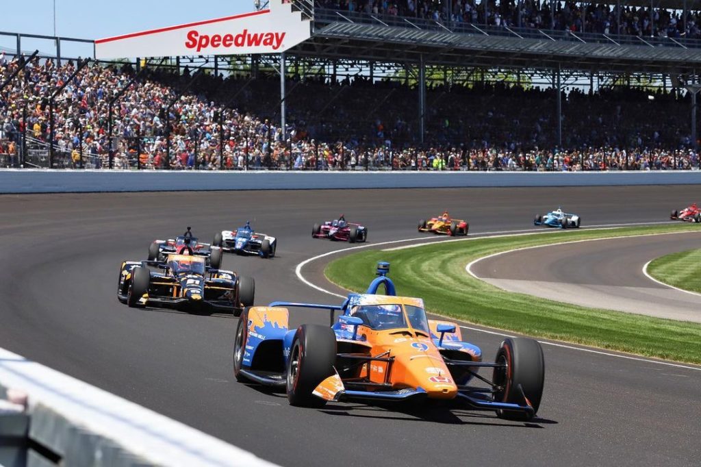 Cars racing at the Indianapolis Motor Speedway. Photo by Instagram user @indianapolismotorspeedway
