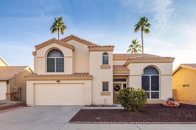 Spanish-style home with palm trees in background in the Awhatukee Foothills neighborhood.