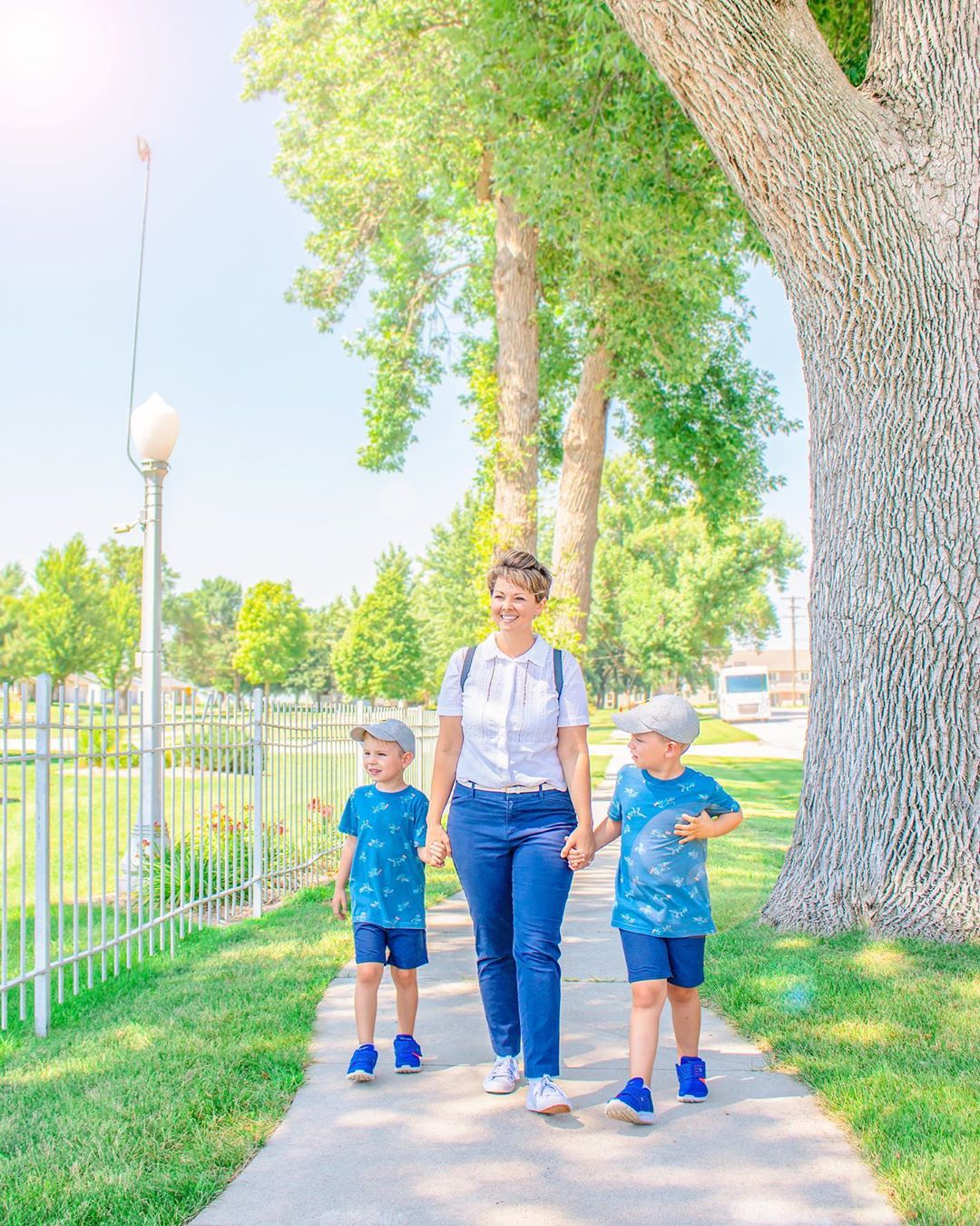 Mom and sons walking through neighborhood. Photo by Instagram user @itsnicandjess