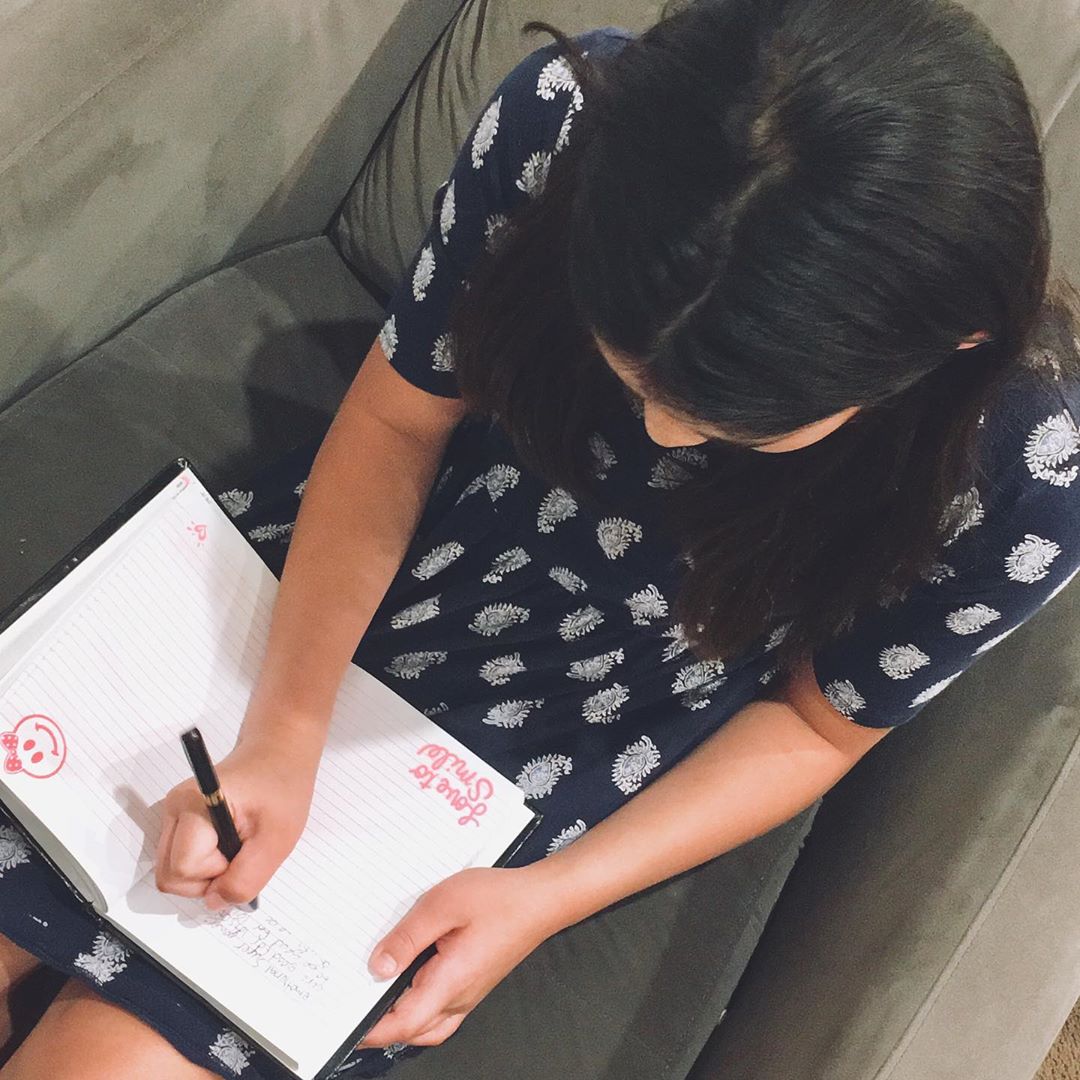 Girl writing in journal. Photo by Instagram user @emotionalsuperpowers