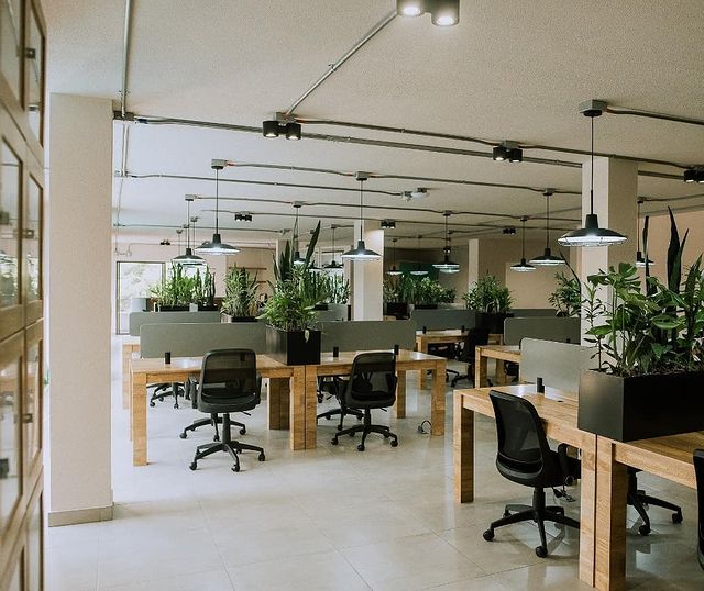 View of a remote working space with many desks and chairs.