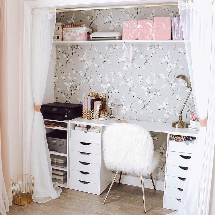 Closet space with printed wall paper and desk