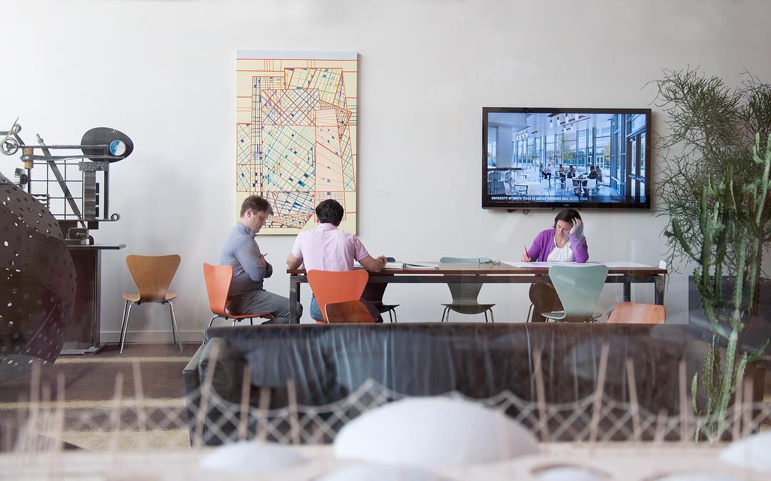 People Working at a Conference Table. Photo by Instagram user @overlandpartners