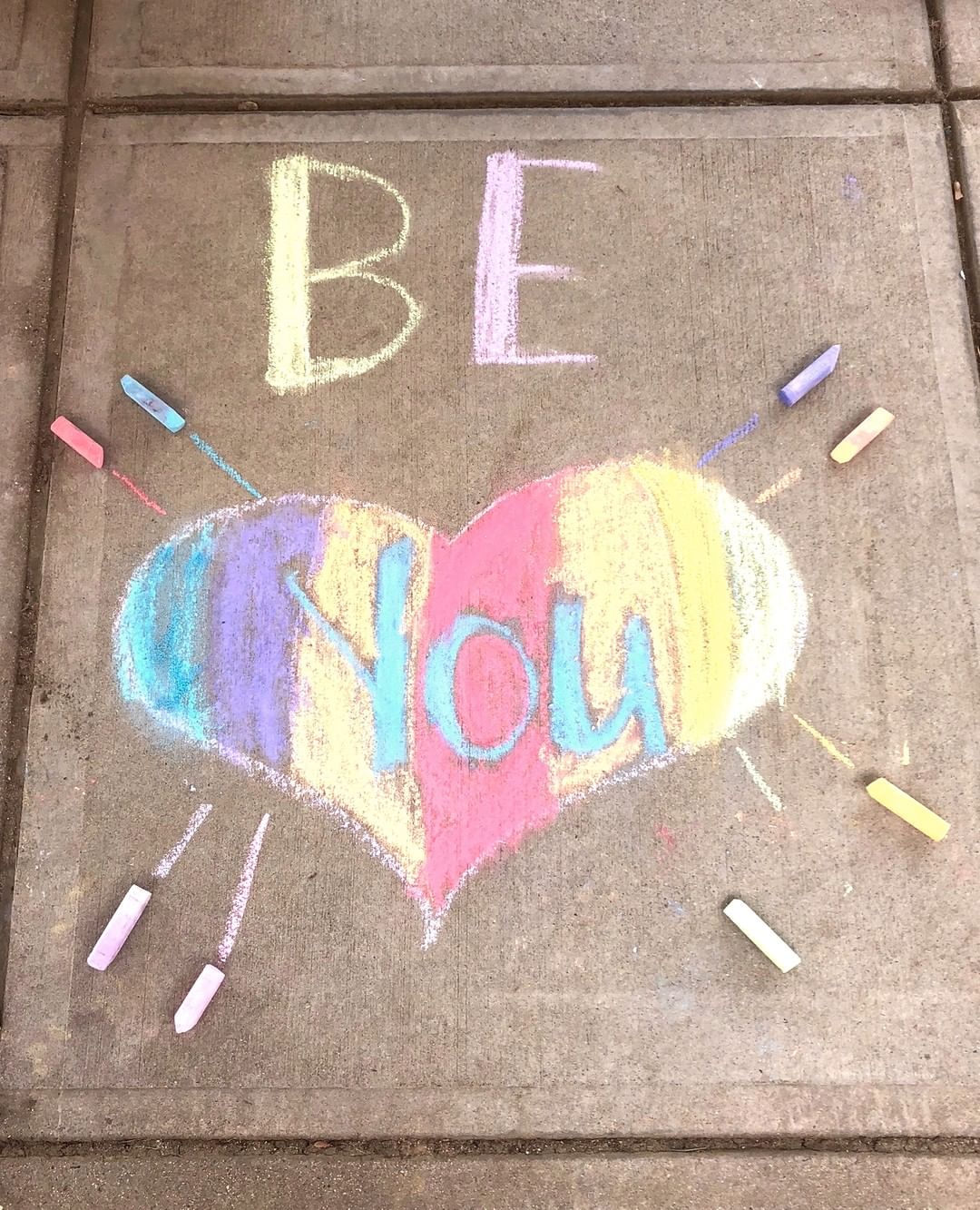 Rainbow chalk art on sidewalk that says be you. Photo by Instagram user @framinghamfpa