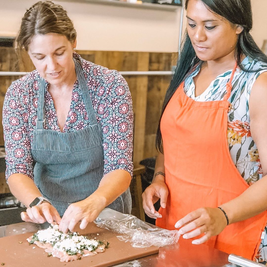Two women wearing aprons cooking. Photo by Instagram user @ljaydeeh