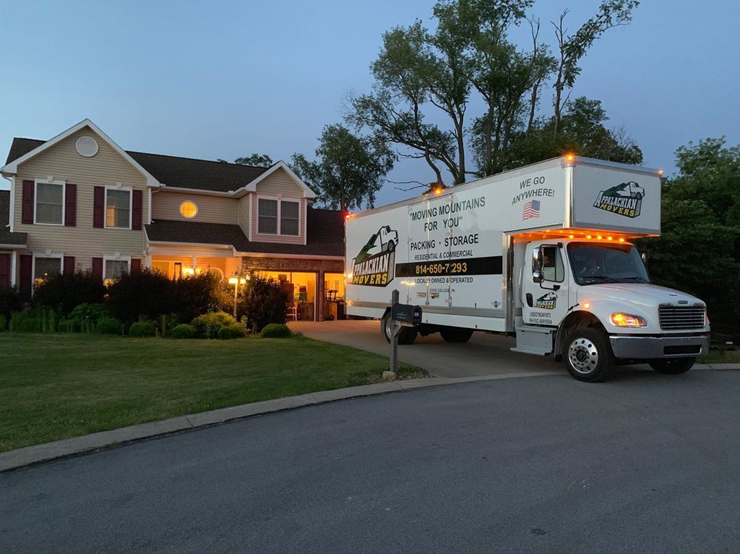 Moving truck parked outside of house at dusk. Photo by Instagram user @appalachianmoversllc