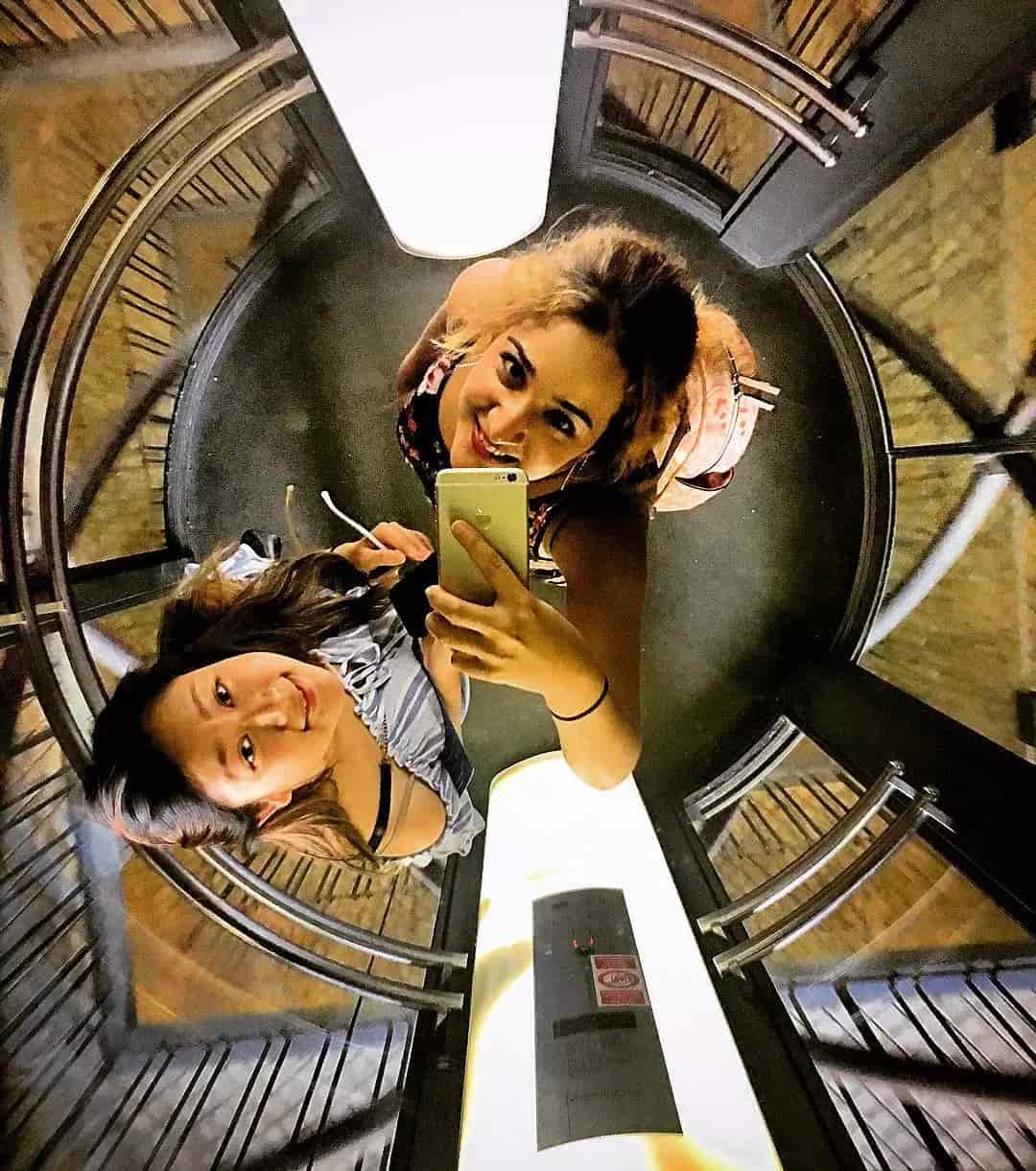 Two girls taking a picture in elevator. Photo by Instagram user @ruccci.gucci