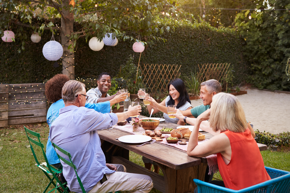 Group of neighbors at a backyard dinner party