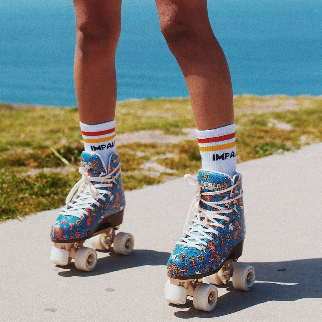 A shot of someone wearing blue impala quad skates. 