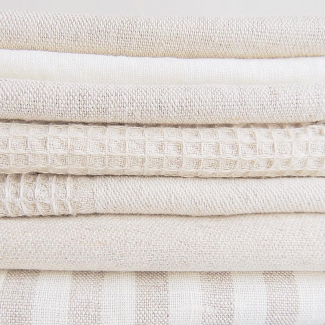 Stack of bed linens. Photo by Instagram user @pleaseorganiseme