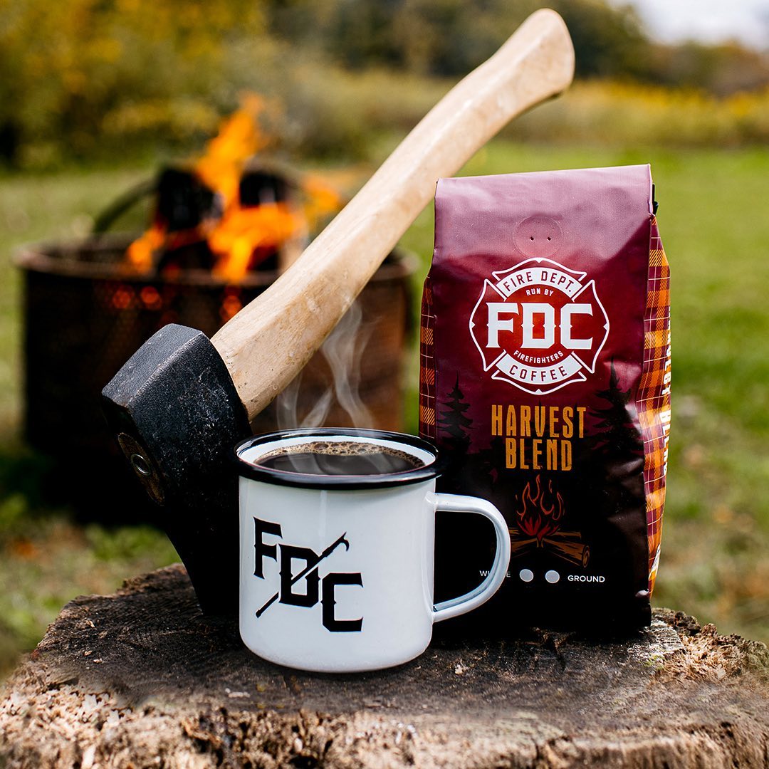 Cup of Coffee, Bag of Fire Department Coffee, and Hatchet on a Stump. Photo by Instagram user @firedeptcoffee