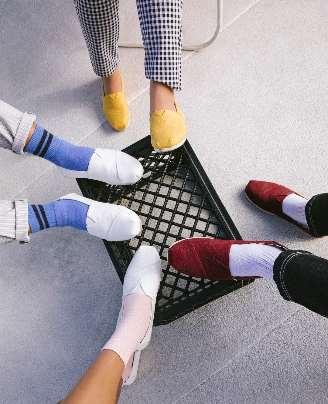 People Putting Their Feet on a Milk Crate Wearing TOMS. Photo by Instagram user @toms