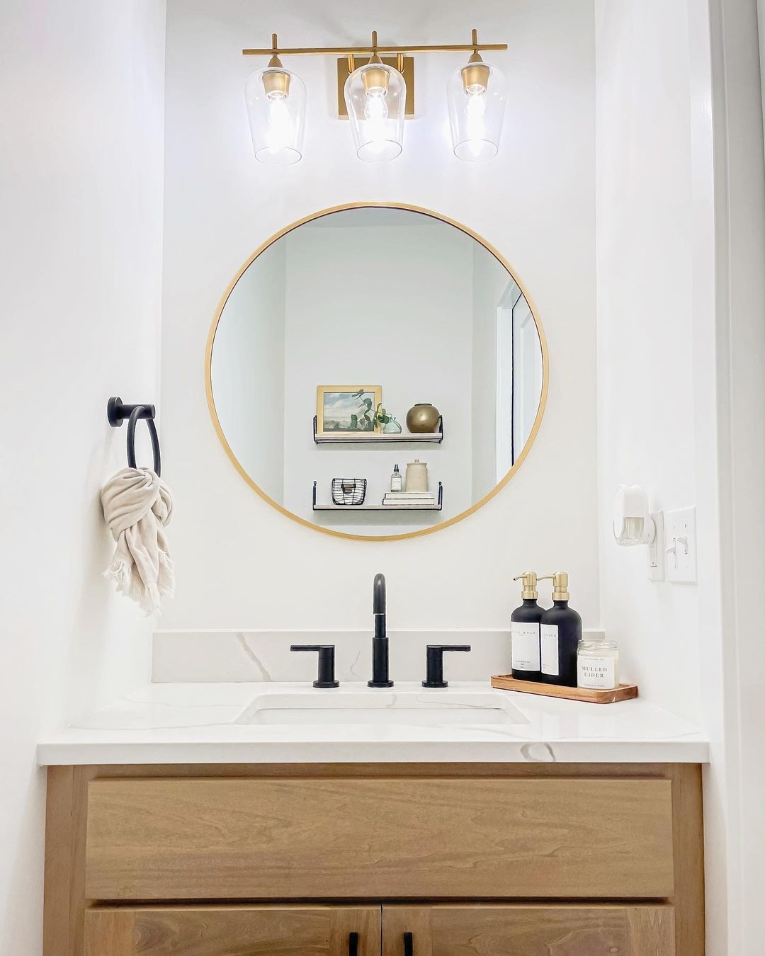 Updated Guest Bathroom with Round Mirror. Photo by Instagram user @pleasantlybuilt