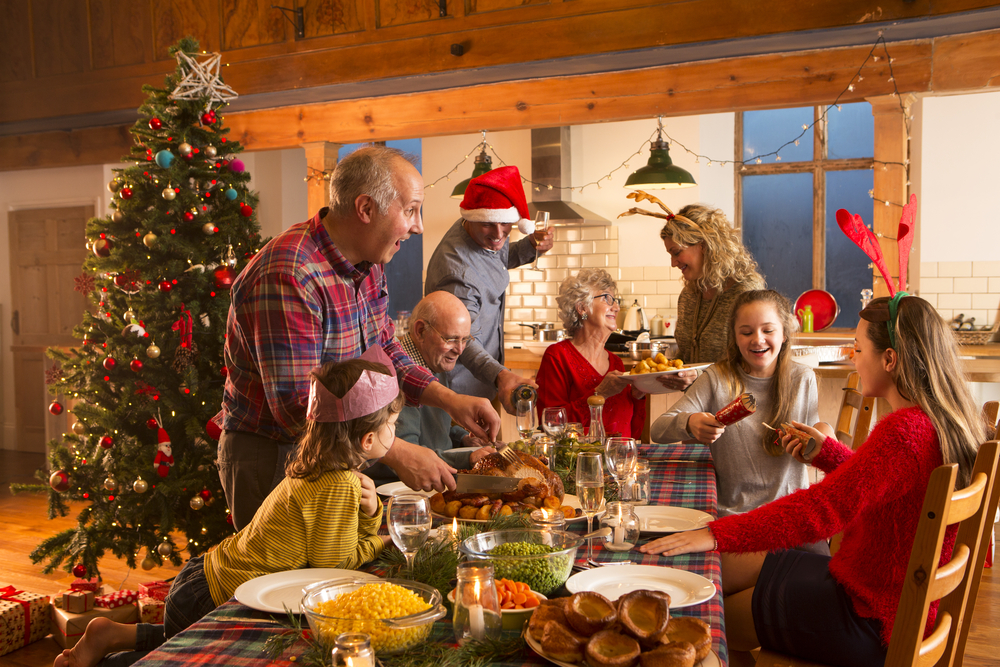 Family gathered around dining table during winter holiday celebration