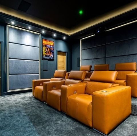 Blue Theater Room with Tan Recliner Seats. Instagram photo by @hometheaters.of.insta