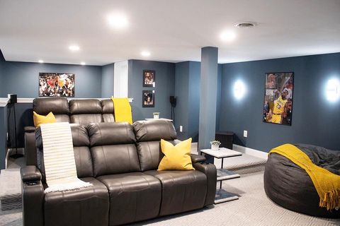 Blue Home Theater Room with Row Seating. Instagram Photo by @kristell_interiors