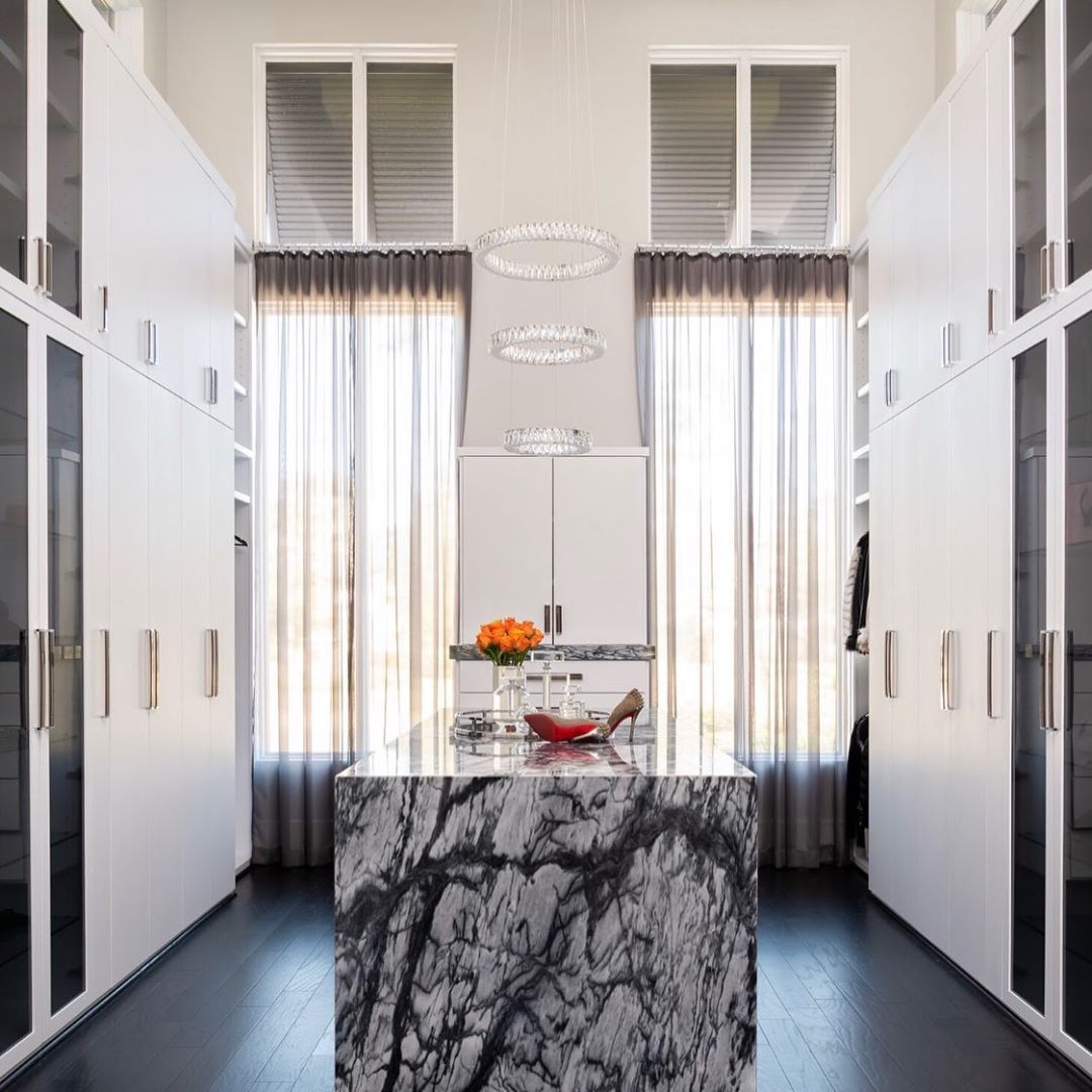 Contemporary closet with marble island. Photo by Instagram user @teripughstudio