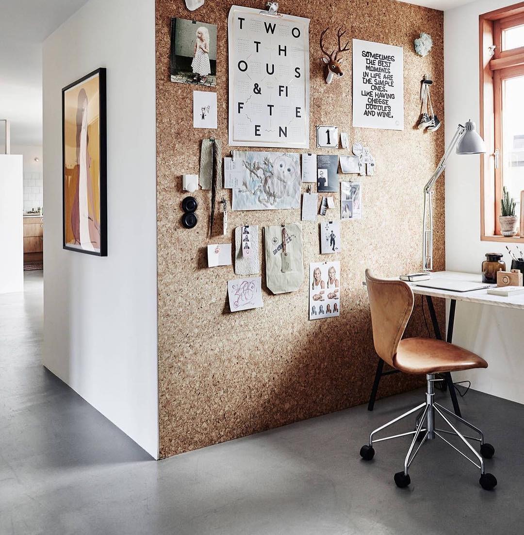 home office setup with a full cork board wall for organization photo by Instagram user @morethanjustanartist