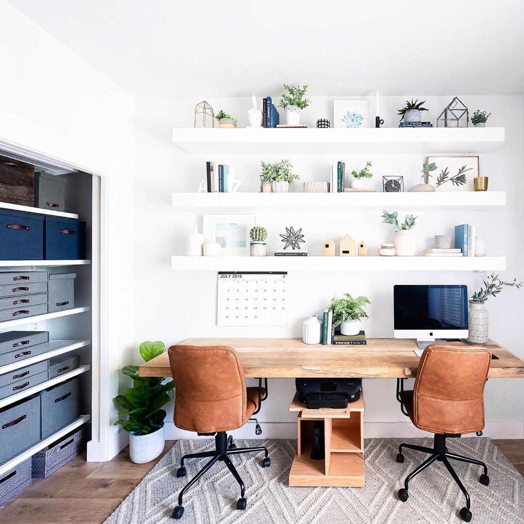 wall mounted desk with two chairs and floating shelves photo by Instagram user @mintandpinedesign