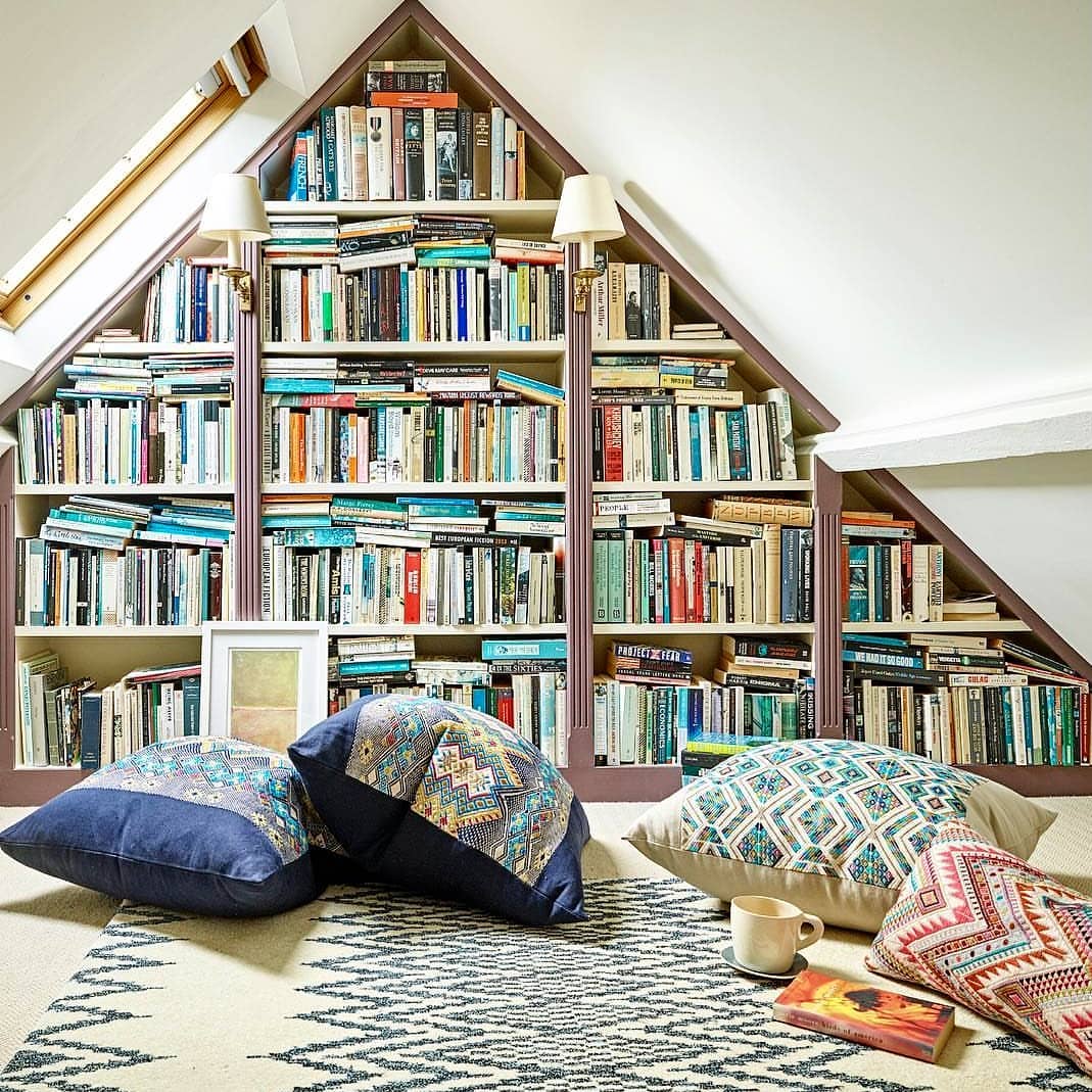 attic library with floor seating and natural lighting photo by Instagram user @uk_interiors_collective