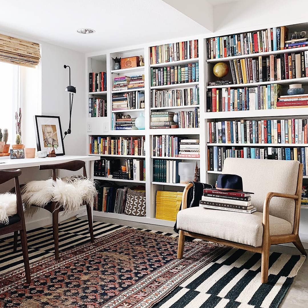 home office library with large area rug on floor and rustic seating photo by Instagram user @undecorated_home