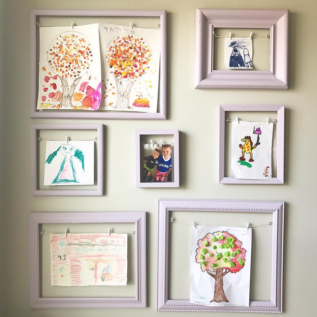 Frames with Interchangable Childrens Artwork on Wall. Photo by Instagram user @papersnpencilsathome