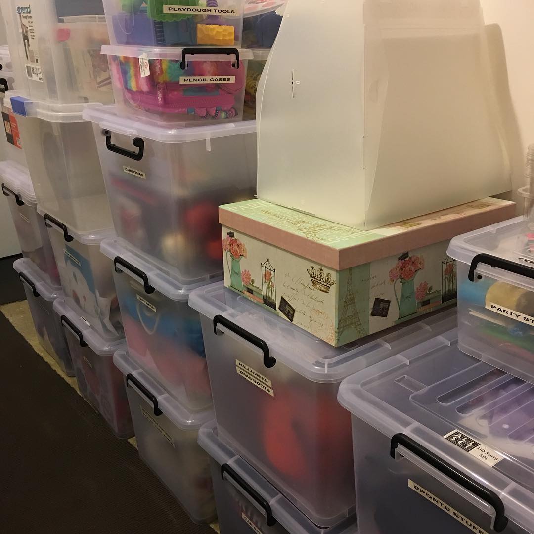 Junk Arranged in Plastic Tubs in Storage Room. Photo by Instagram user @this_mama_loves