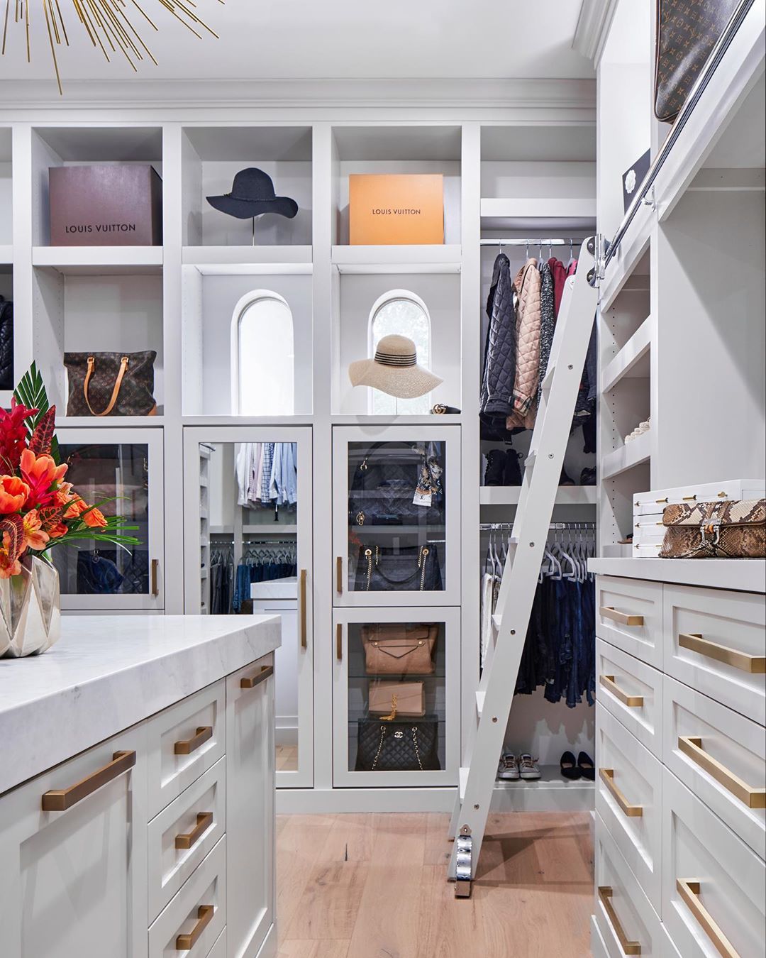 Walk-in closet with rolling ladder. Photo by Instagram user @havendesignandconstruction