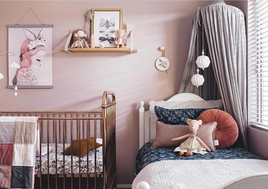 Vintage pink shared kids bedroom design for baby and toddler.