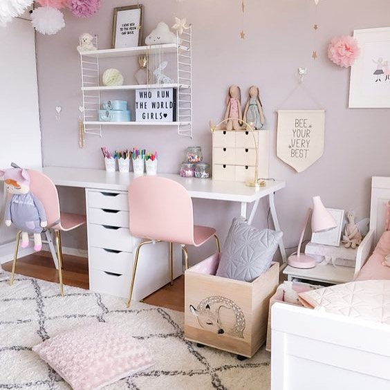 Pink shared kids room with desk for two.