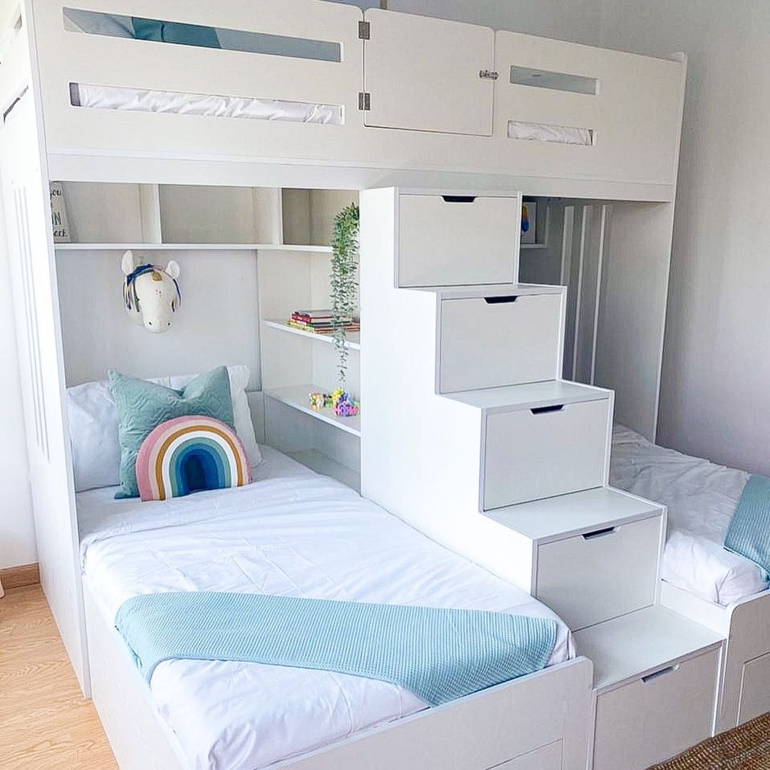 Bedroom with three beds in a bunk bed setup.